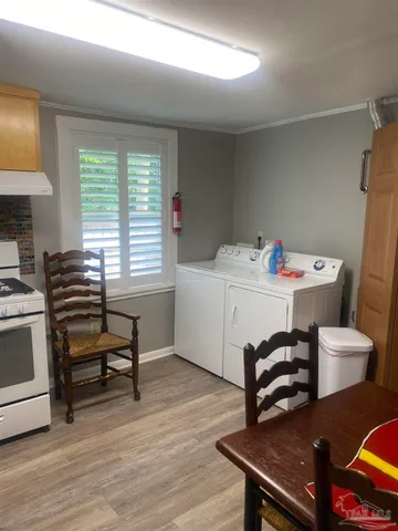 a utility room with a window a washer and dryer