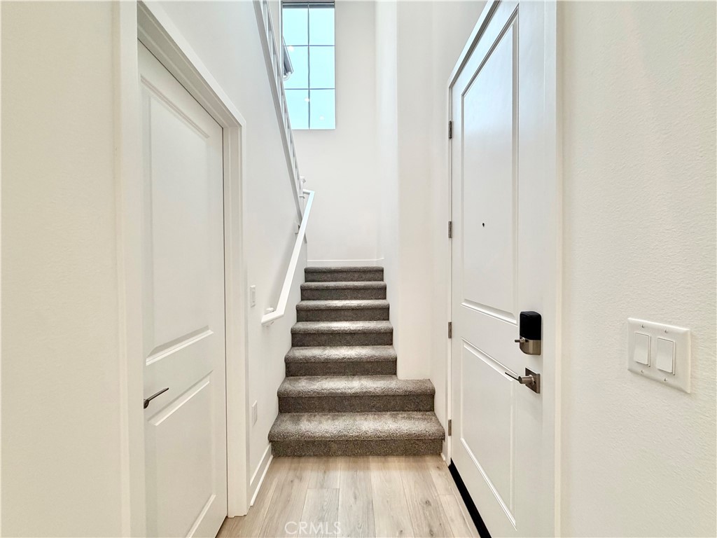 26893 Rubicon Road Menifee, CA 92586 - Photo 13 of 32 a view of a hallway with wooden floor and entryway