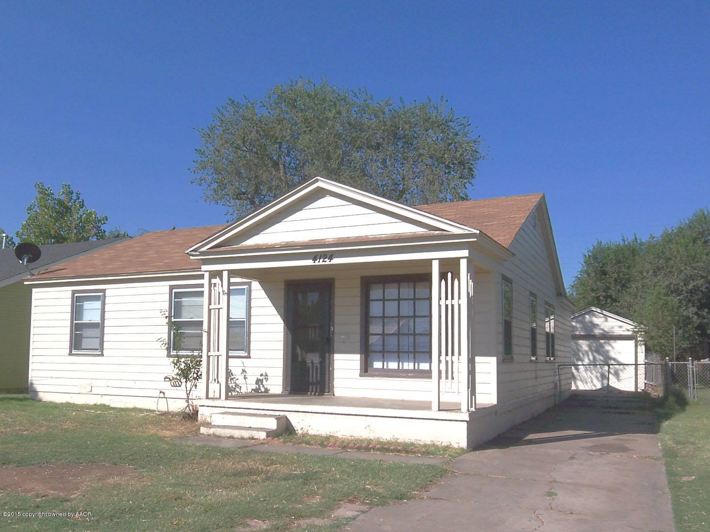 4124 Parker Street Amarillo, TX 79110 - Photo 1 of 12 a front view of a house with a yard and garage