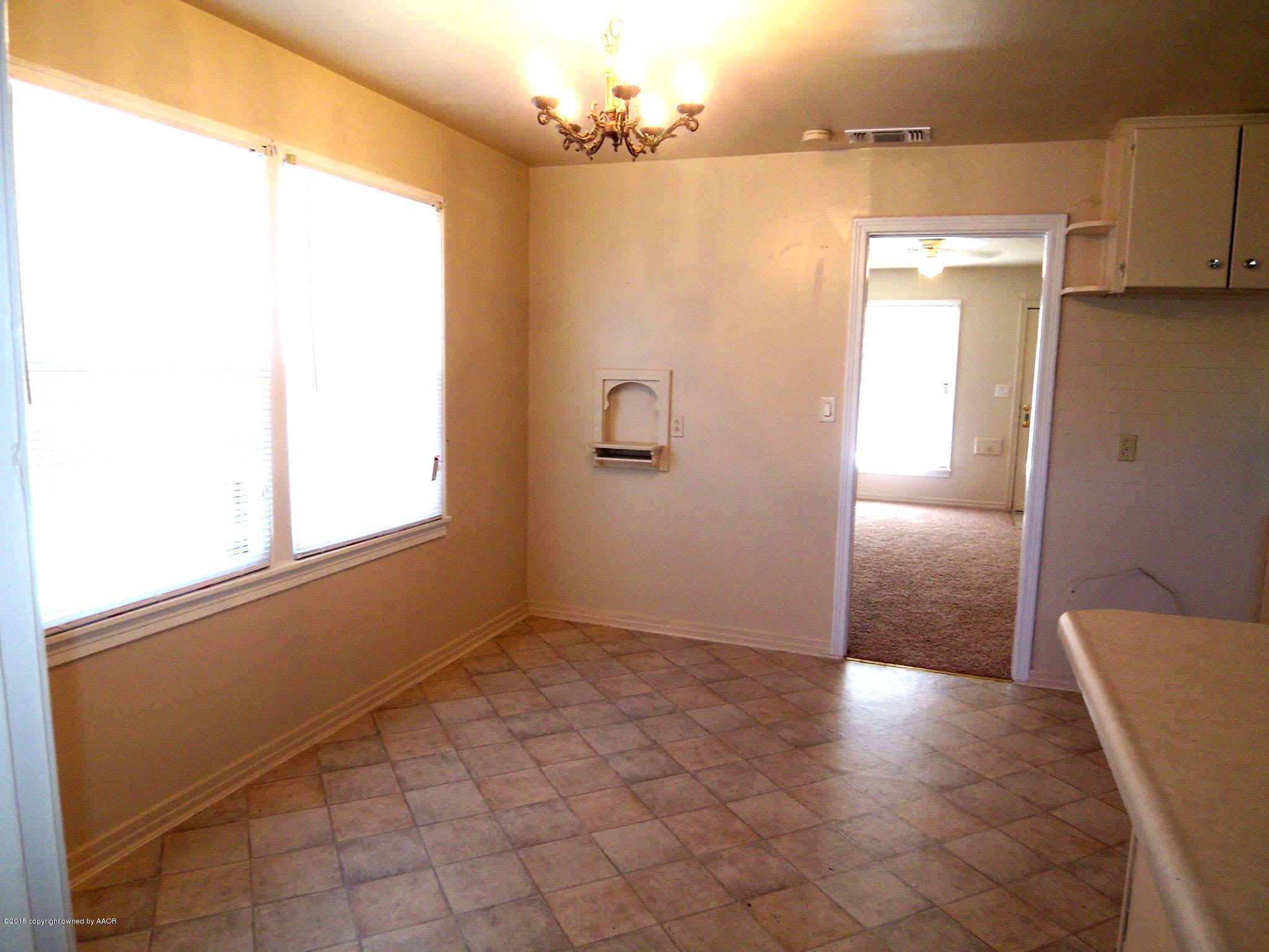 4124 Parker Street Amarillo, TX 79110 - Photo 4 of 12 a view of a big room with windows and chandelier