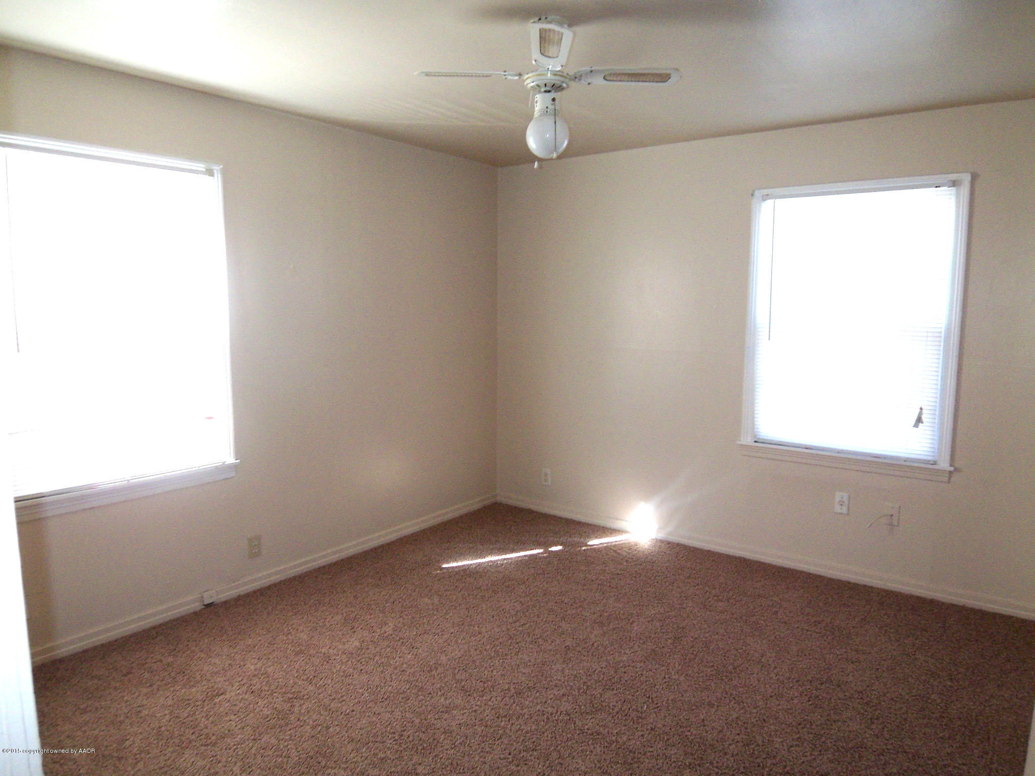 4124 Parker Street Amarillo, TX 79110 - Photo 7 of 12 an empty room with a window and a fan