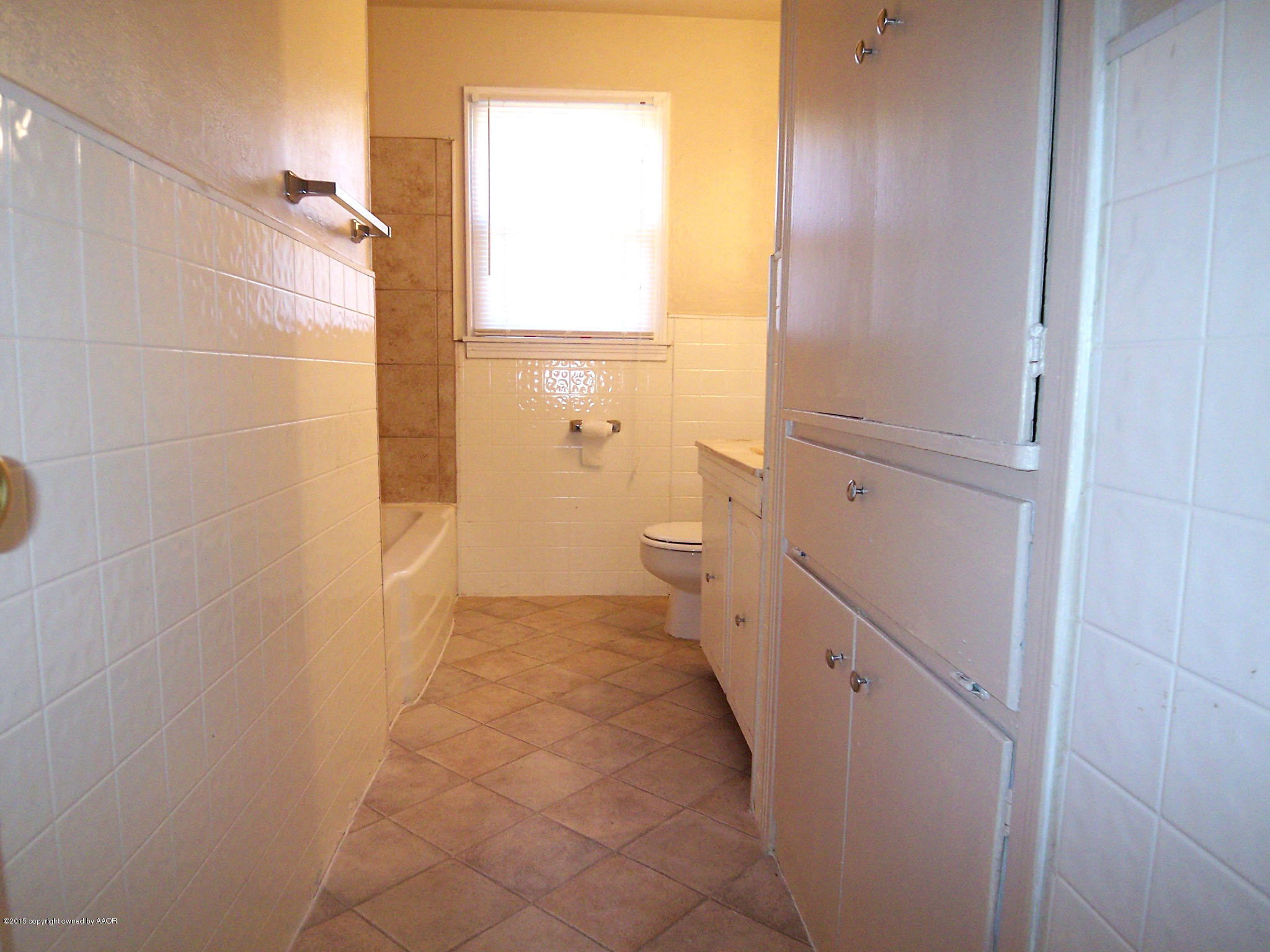 4124 Parker Street Amarillo, TX 79110 - Photo 10 of 12 a bathroom with a granite countertop shower and a toilet