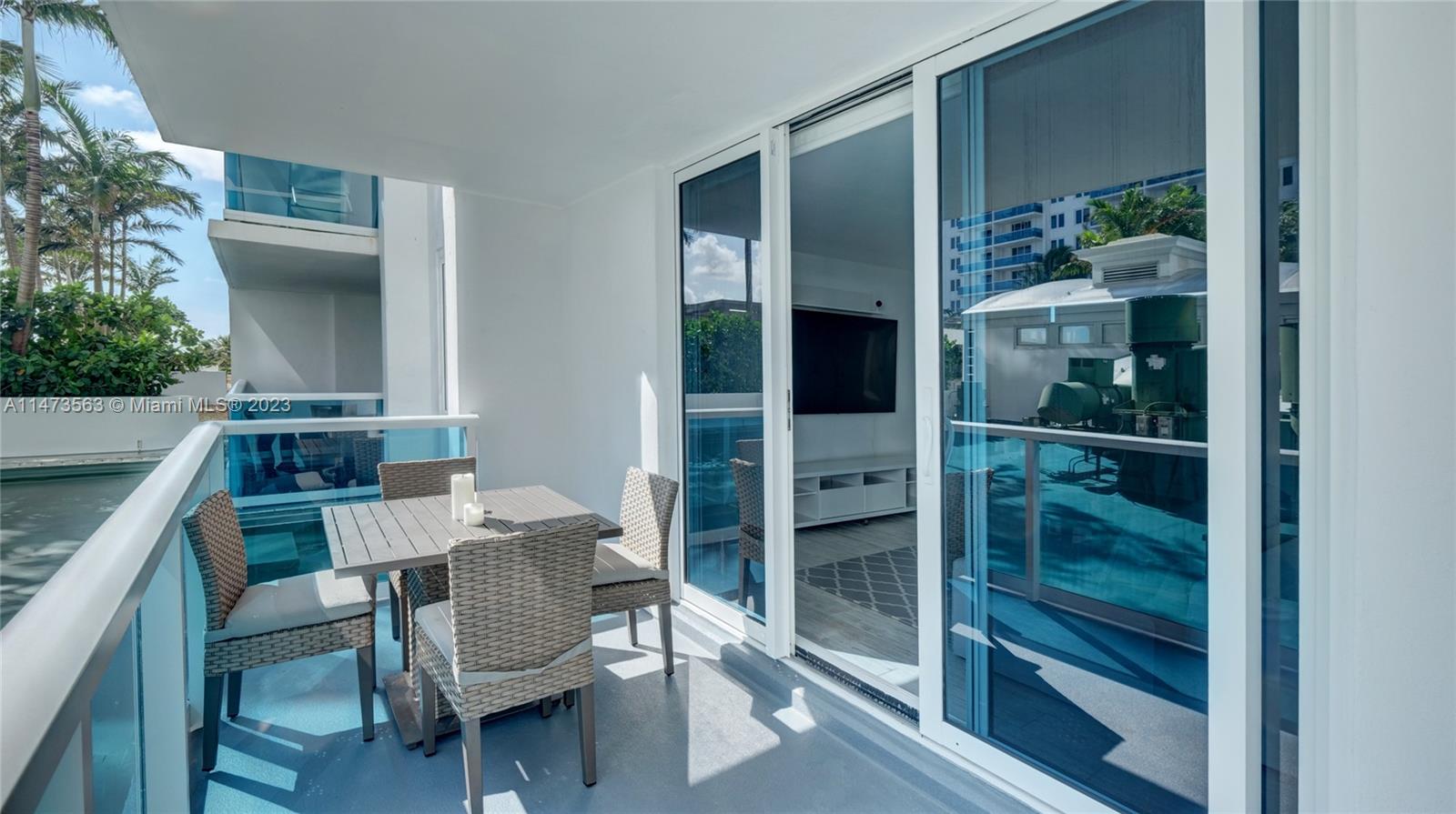 2301 Collins Avenue, Unit 321 Miami Beach, FL 33139 - Photo 1 of 33 a balcony with table and chairs