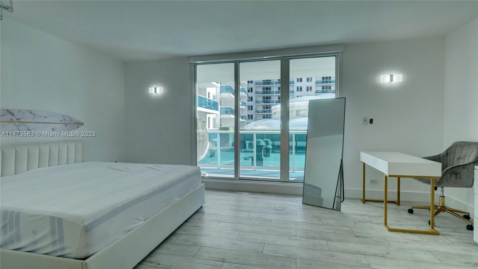 2301 Collins Avenue, Unit 321 Miami Beach, FL 33139 - Photo 11 of 33 a bedroom with a bed and a large window