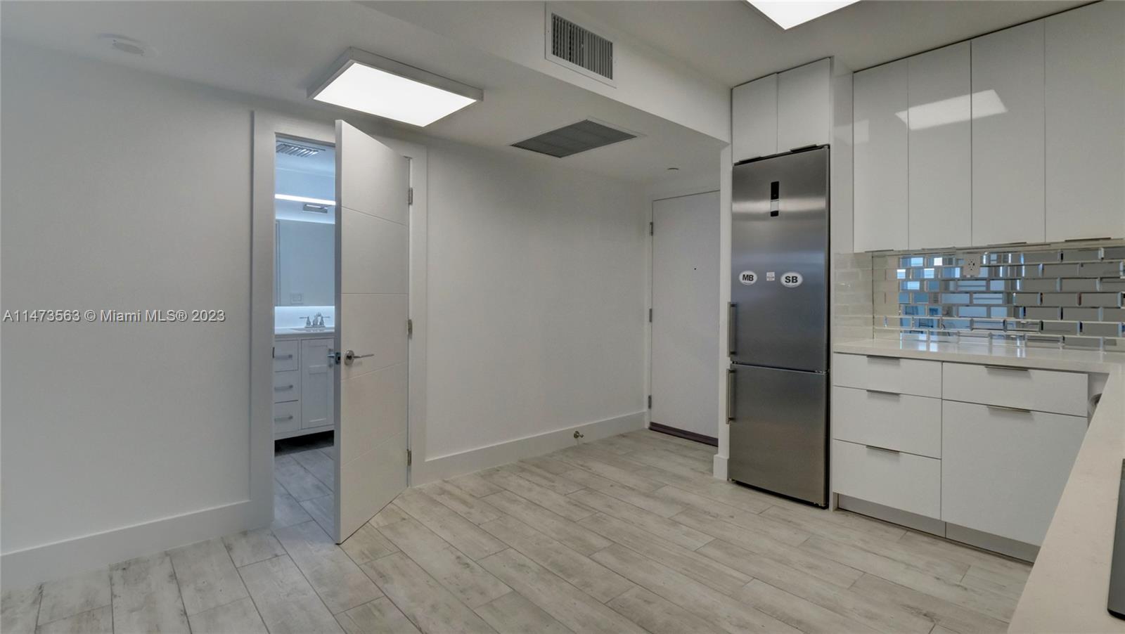 2301 Collins Avenue, Unit 321 Miami Beach, FL 33139 - Photo 17 of 33 wooden floor and cabinet in a room