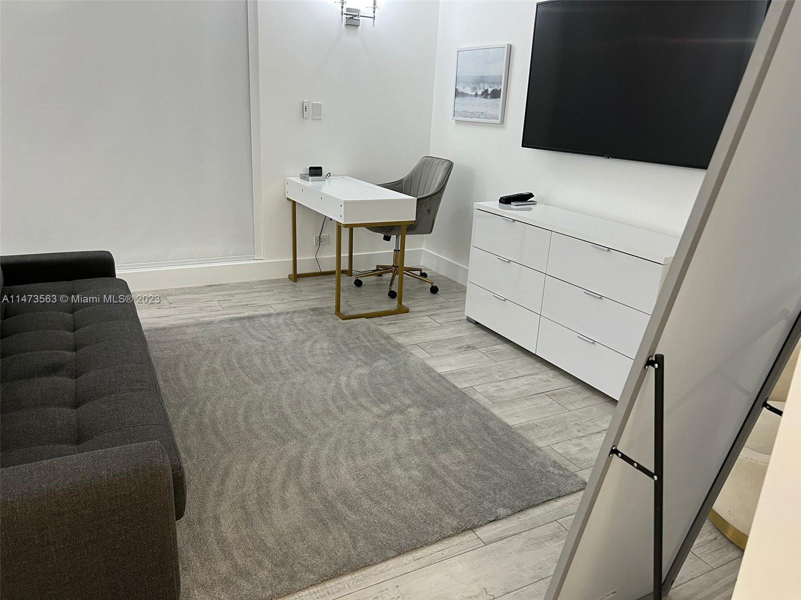 2301 Collins Avenue, Unit 321 Miami Beach, FL 33139 - Photo 23 of 33 a living room with furniture and a flat screen tv