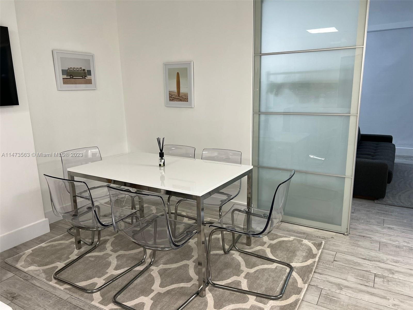 2301 Collins Avenue, Unit 321 Miami Beach, FL 33139 - Photo 24 of 33 a table and chairs in a room