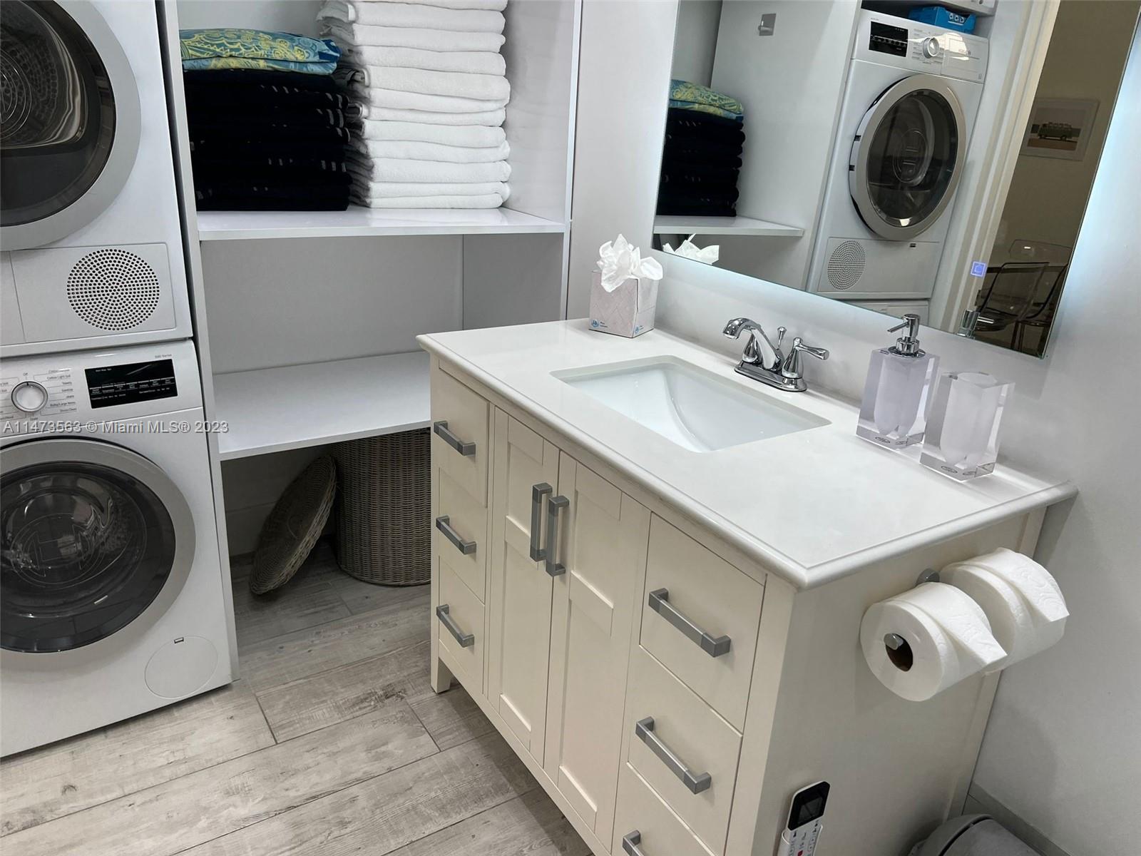 2301 Collins Avenue, Unit 321 Miami Beach, FL 33139 - Photo 25 of 33 a bathroom with a sink a washer and dryer