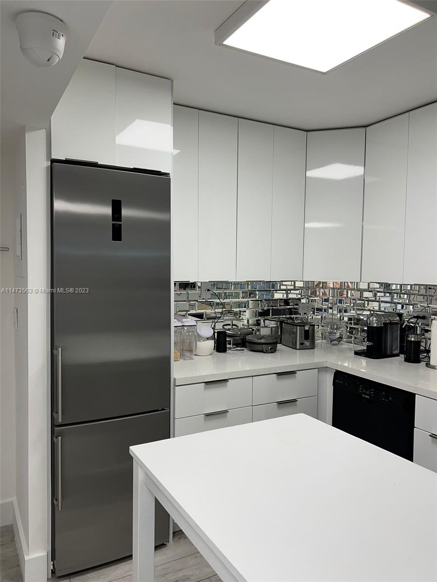 2301 Collins Avenue, Unit 321 Miami Beach, FL 33139 - Photo 26 of 33 a kitchen with a sink a stove and refrigerator