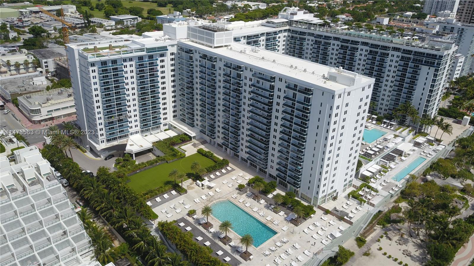 2301 Collins Avenue, Unit 321 Miami Beach, FL 33139 - Photo 4 of 33 a large building with a tree in the background