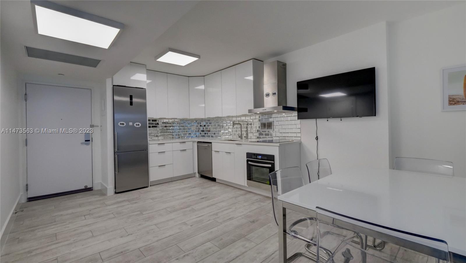 2301 Collins Avenue, Unit 321 Miami Beach, FL 33139 - Photo 6 of 33 a kitchen with a stove a sink and a microwave