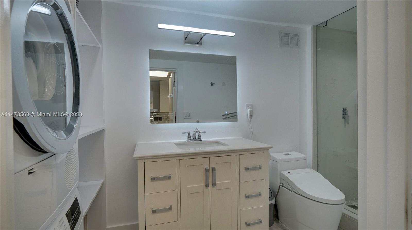 2301 Collins Avenue, Unit 321 Miami Beach, FL 33139 - Photo 10 of 33 a bathroom with a toilet sink and mirror