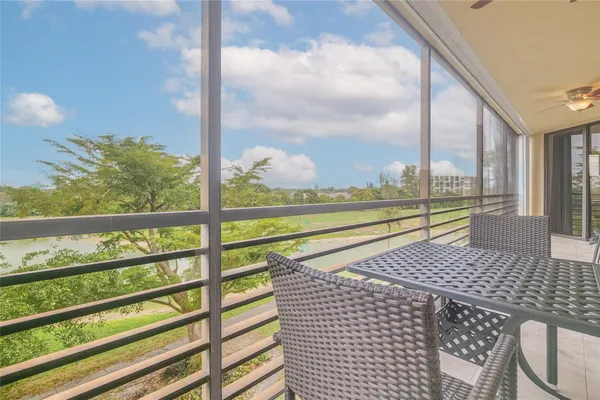 a view of a balcony with chairs and a table