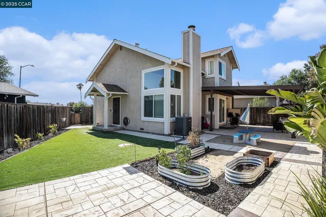 a view of a house with backyard sitting area and swimming pool
