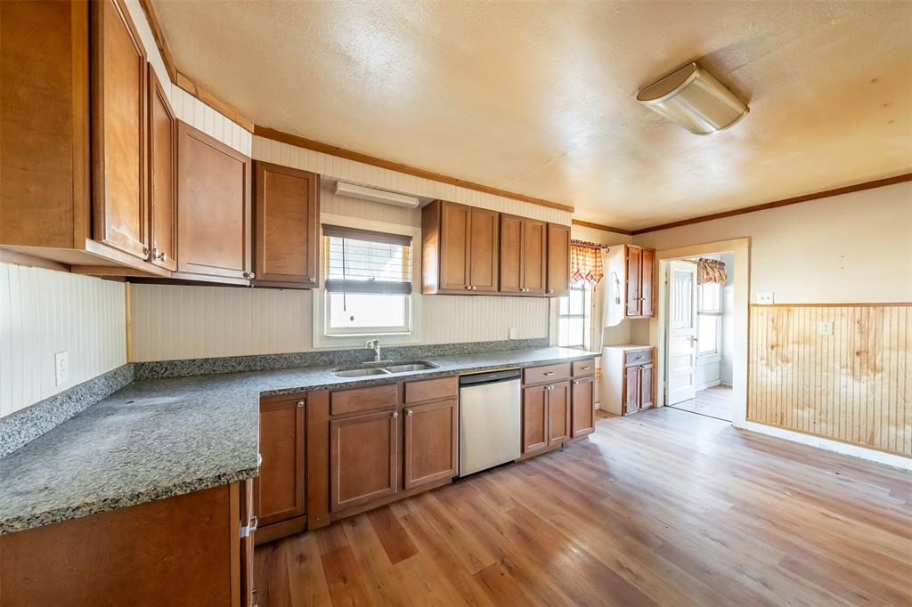 3710 County Road 334 Tyler, TX 75708 - Photo 9 of 29 a large kitchen with granite countertop a sink window and cabinets