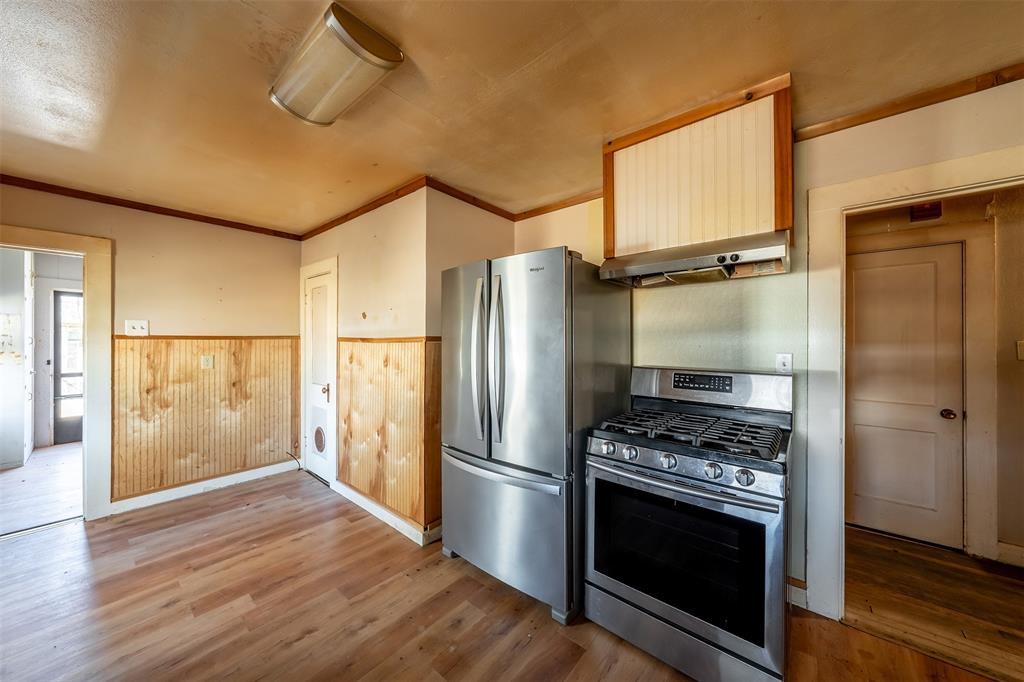 3710 County Road 334 Tyler, TX 75708 - Photo 10 of 29 a kitchen with stainless steel appliances wooden floor and a refrigerator