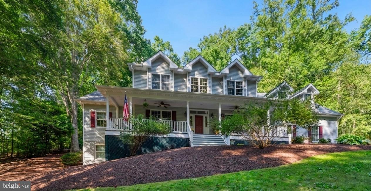 6601 Colchester Road Fairfax Station, VA 22039 - Photo 2 of 78 a front view of a house with a yard and green space