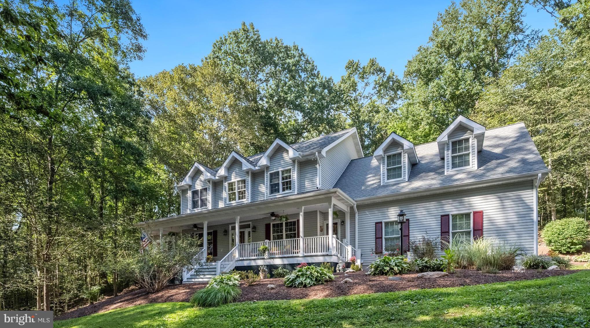 6601 Colchester Road Fairfax Station, VA 22039 - Photo 3 of 78 a front view of a house with garden and trees