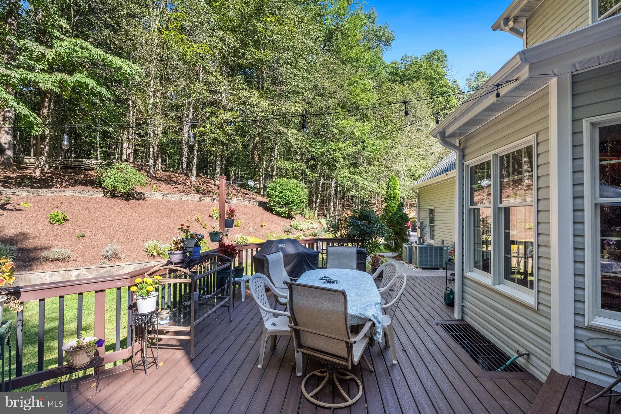 6601 Colchester Road Fairfax Station, VA 22039 - Photo 35 of 78 a view of a patio with table and chairs potted plants with wooden floor and fence