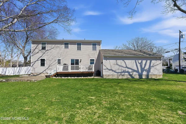 a view of a house with a yard and sitting area
