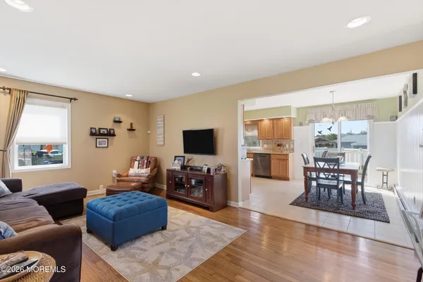 a living room with furniture wooden floor and a flat screen tv