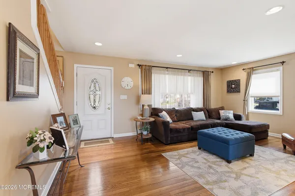a living room with furniture window and wooden floor