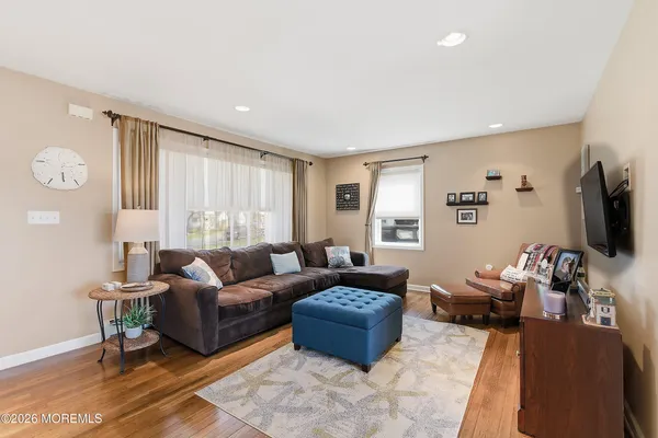 a living room with furniture a large window and a flat screen tv