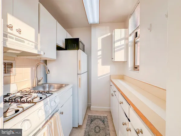 a kitchen with a sink stove and refrigerator