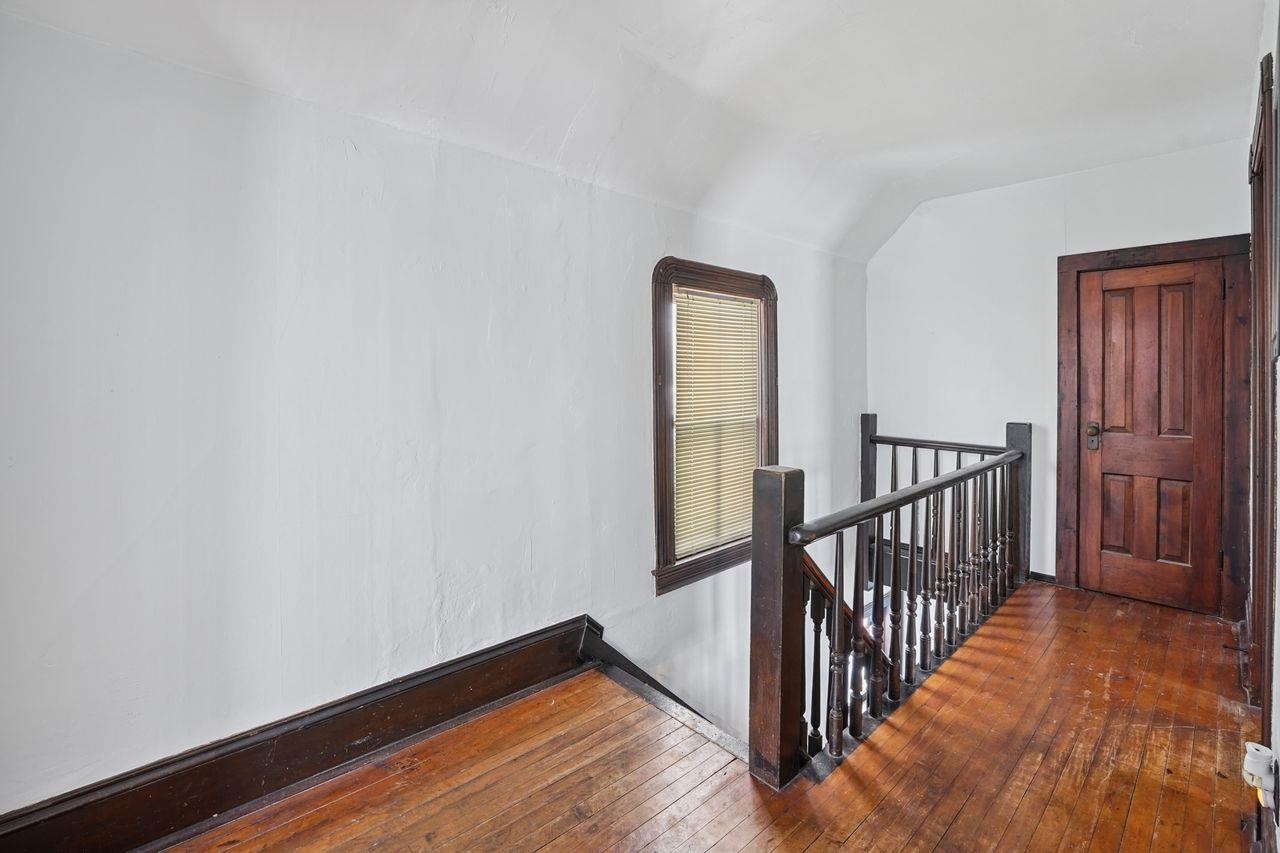802 3rd Avenue East Ashland, WI 54806 - Photo 15 of 22 Corridor with an upstairs landing, dark wood-style floors, and vaulted ceiling