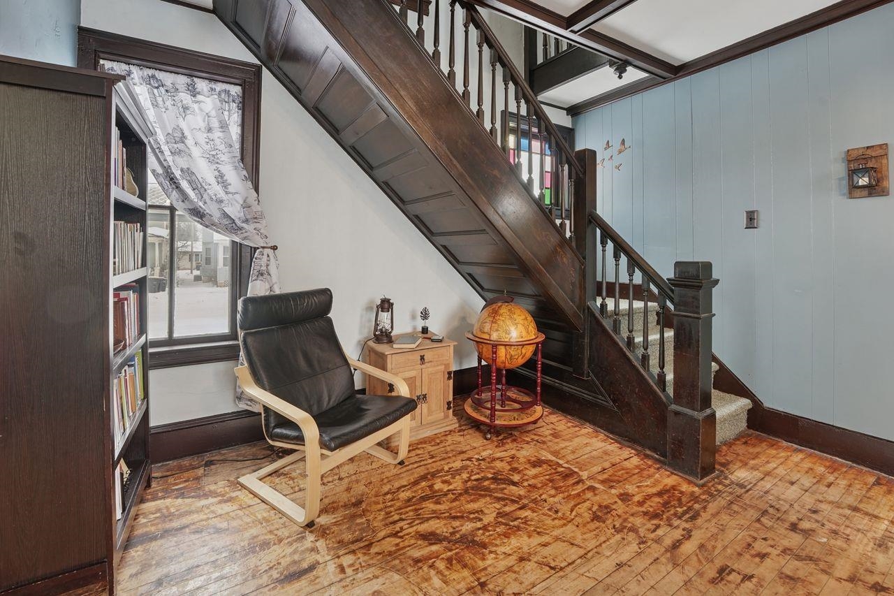 802 3rd Avenue East Ashland, WI 54806 - Photo 16 of 22 Living area with stairway, wood walls, and hardwood / wood-style floors