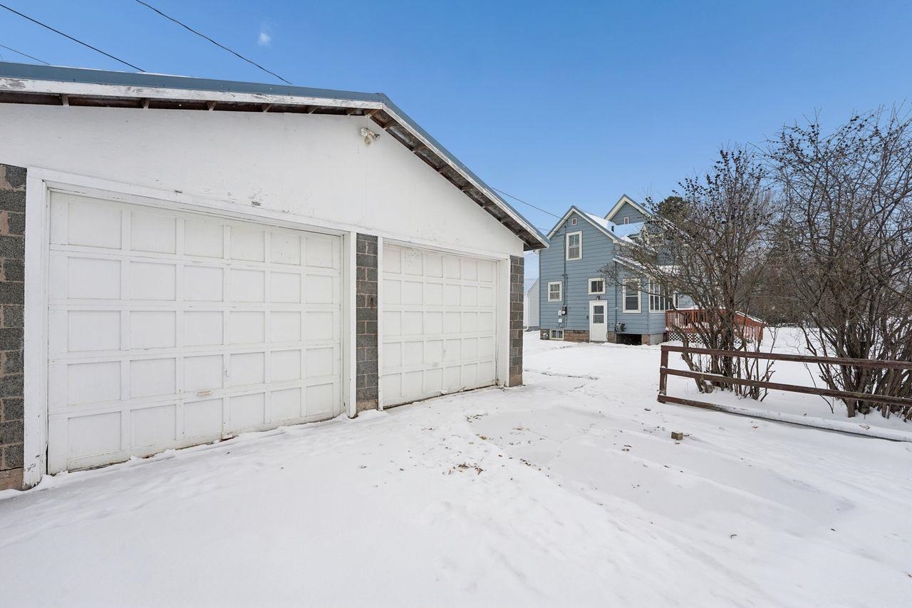 802 3rd Avenue East Ashland, WI 54806 - Photo 20 of 22 Snow covered garage featuring a garage