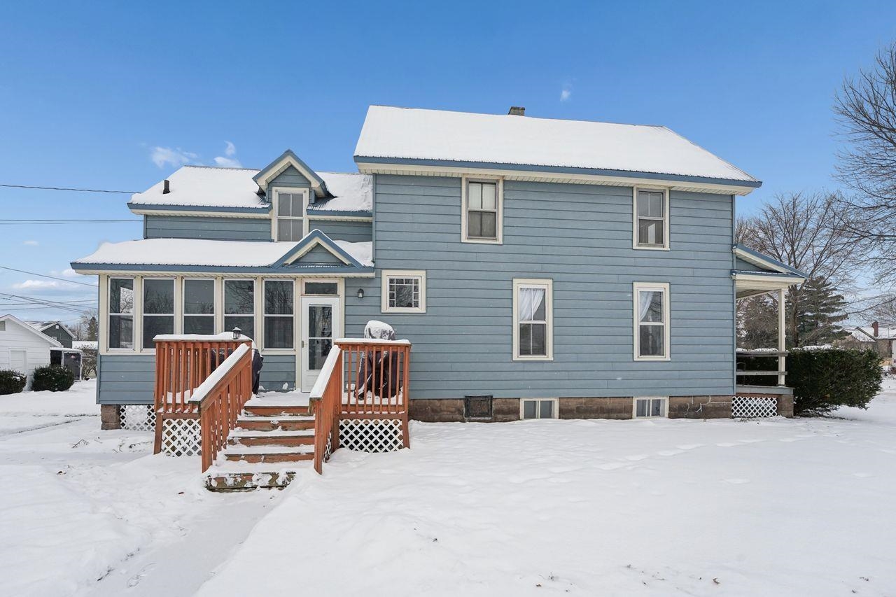 802 3rd Avenue East Ashland, WI 54806 - Photo 21 of 22 Snow covered rear of property featuring a sunroom