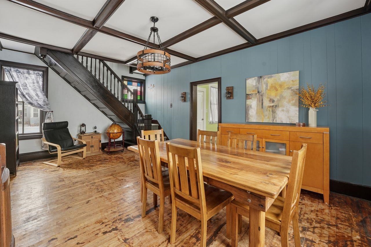 802 3rd Avenue East Ashland, WI 54806 - Photo 5 of 22 Dining area with coffered ceiling, stairs, wood-type flooring, beam ceiling, and wooden walls