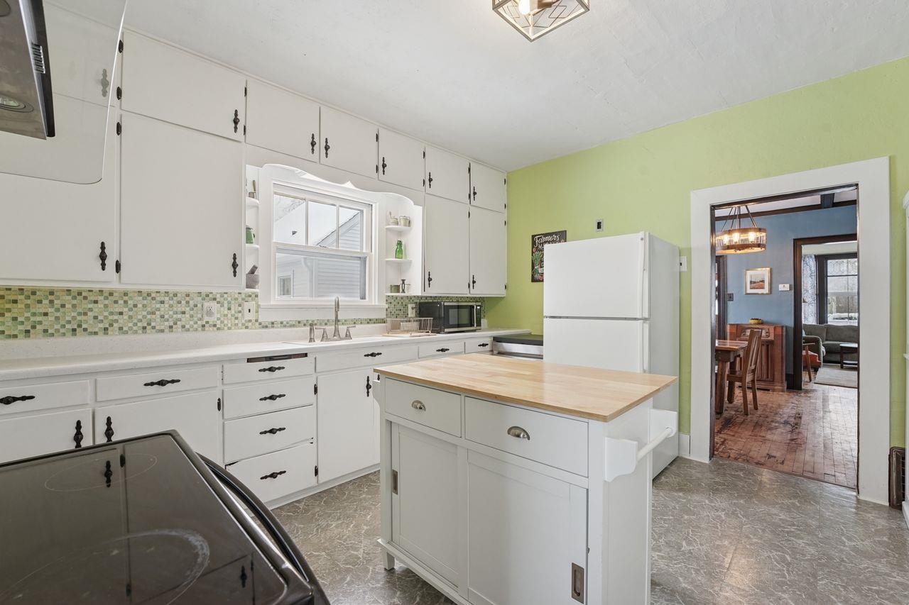 802 3rd Avenue East Ashland, WI 54806 - Photo 8 of 22 Kitchen featuring white cabinetry, wood counters, freestanding refrigerator, black electric range oven, and stainless steel microwave