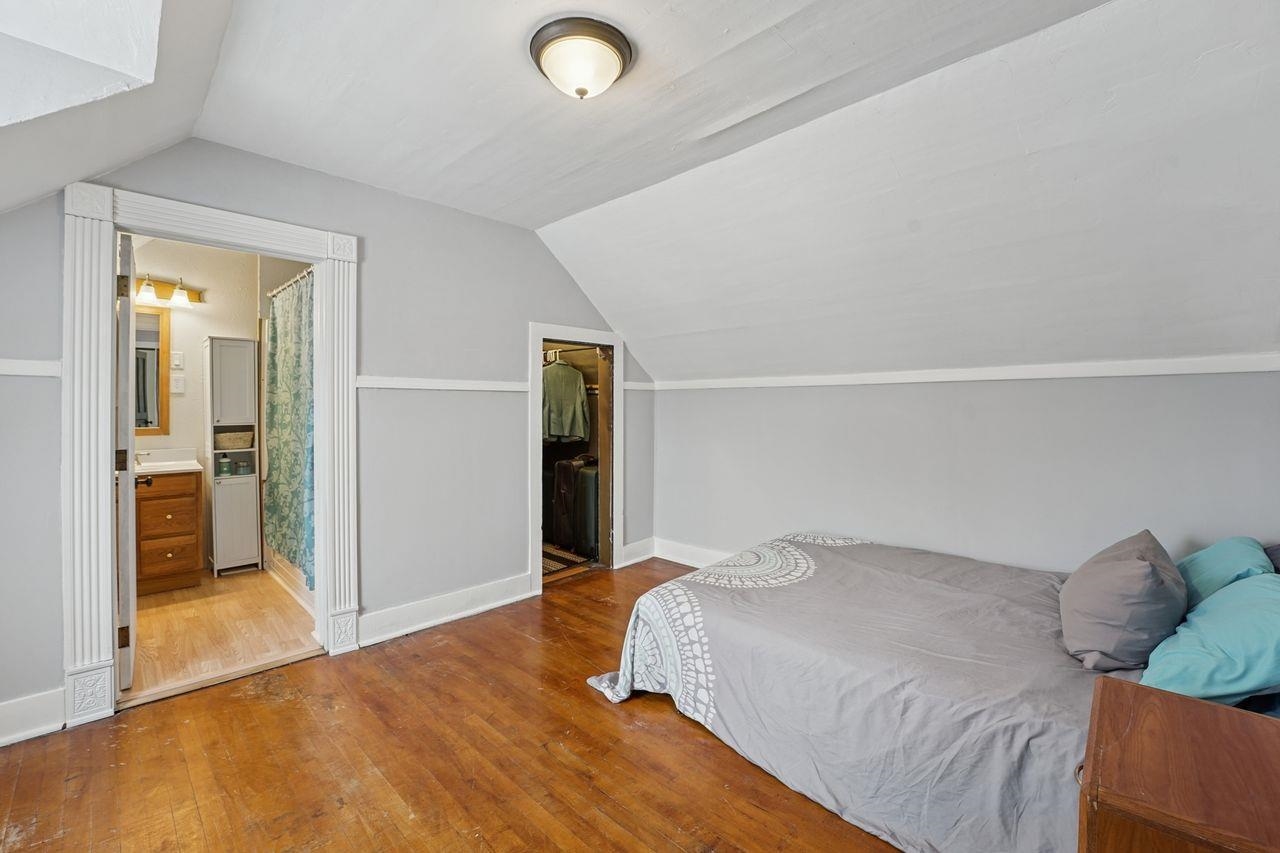 802 3rd Avenue East Ashland, WI 54806 - Photo 9 of 22 Bedroom featuring lofted ceiling, hardwood / wood-style flooring, and ensuite bathroom