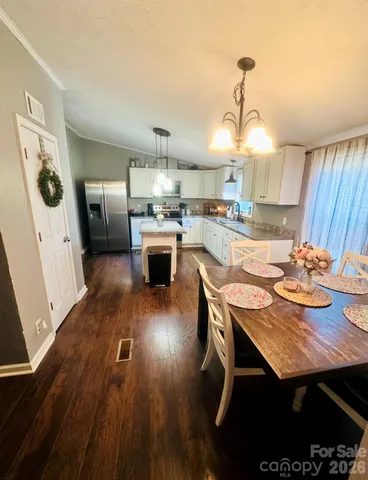 a kitchen with a table and chairs in it