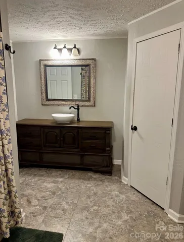 a bathroom with a sink a mirror and vanity