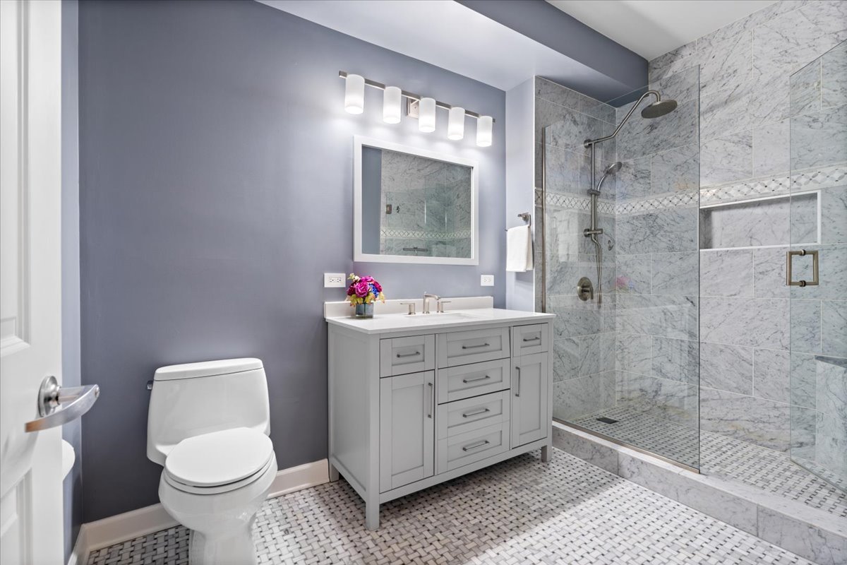 1155 South State Street, Unit 401 Chicago, IL 60605 - Photo 15 of 23 a bathroom with a sink vanity mirror and toilet
