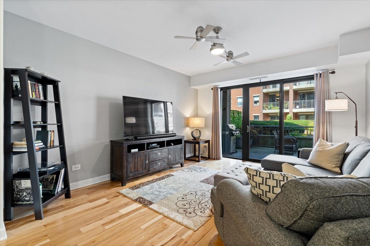 1155 South State Street, Unit 401 Chicago, IL 60605 - Photo 7 of 23 a living room with furniture tv and a flat screen tv