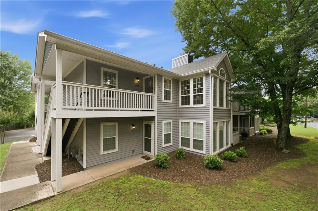 1007 Olde Mill Lane Norcross, GA 30093 - Photo 1 of 32 a front view of a house with a yard