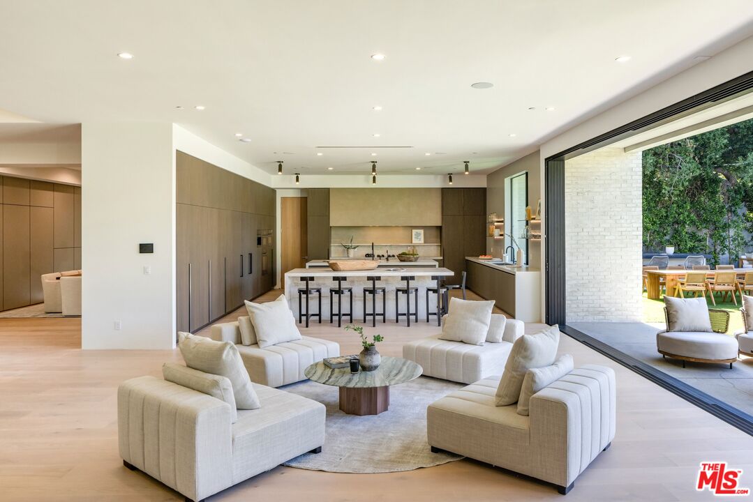 17055 Rancho Street Encino, CA 91316 - Photo 37 of 73 a living room with furniture and a large window