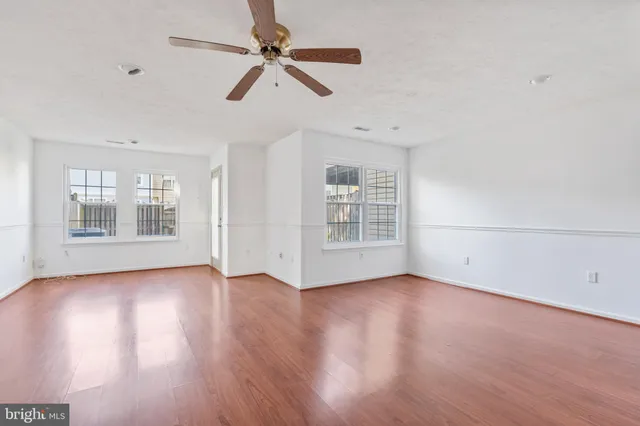 wooden floor in an empty room with a window