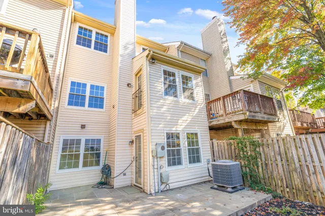 a view of a house with wooden fence next to a road