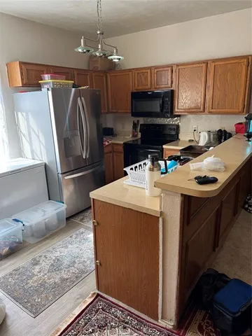 a kitchen with a refrigerator sink and microwave
