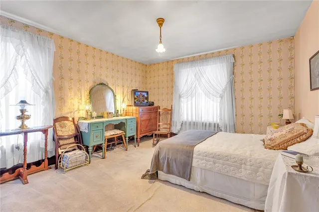 a bedroom with furniture and a window