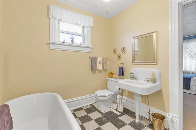 a bathroom with a sink toilet and a mirror