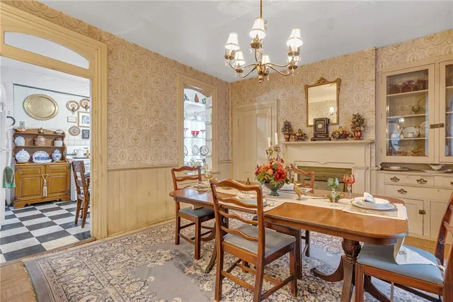 a view of a dining room with furniture and a chandelier
