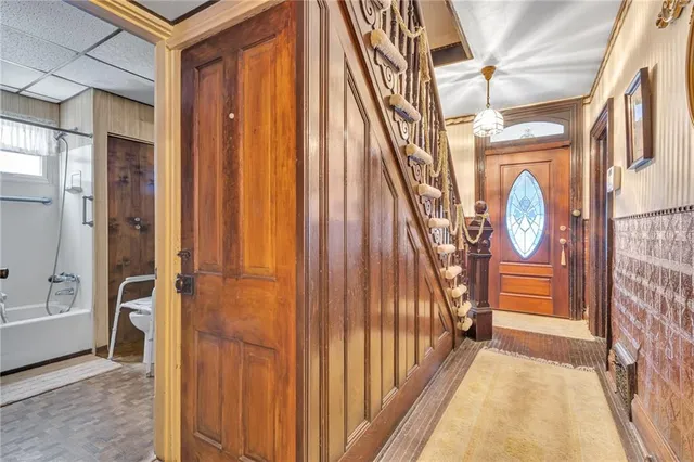 a view of entryway with a grandfather clock and a rug