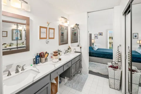 a bathroom with a tub sink and mirror