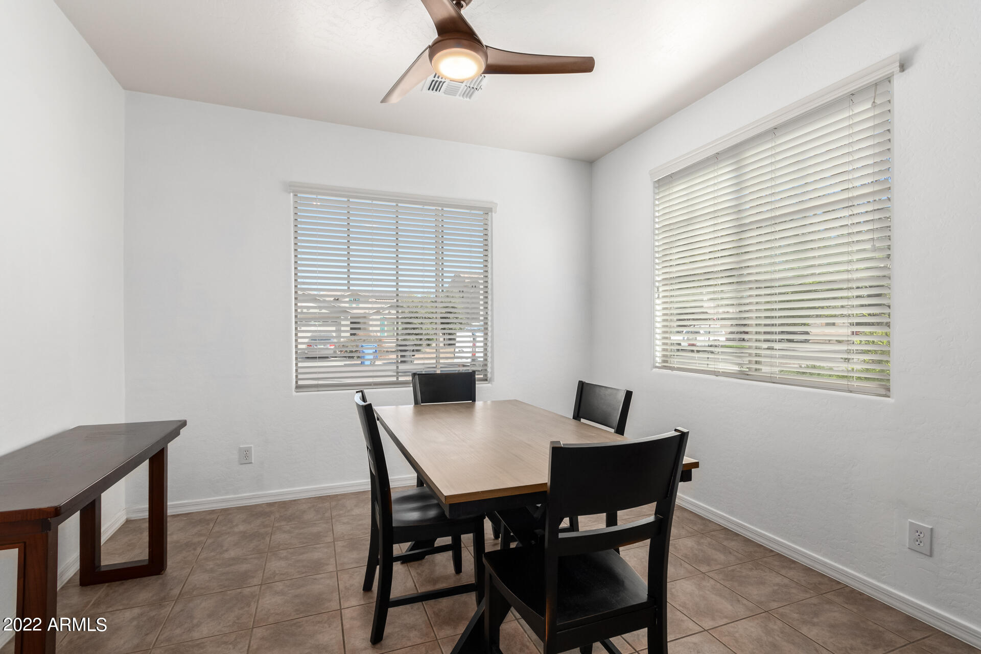 4723 East Timberline Road Gilbert, AZ 85297 - Photo 9 of 30 a view of a dining room with a table and chairs